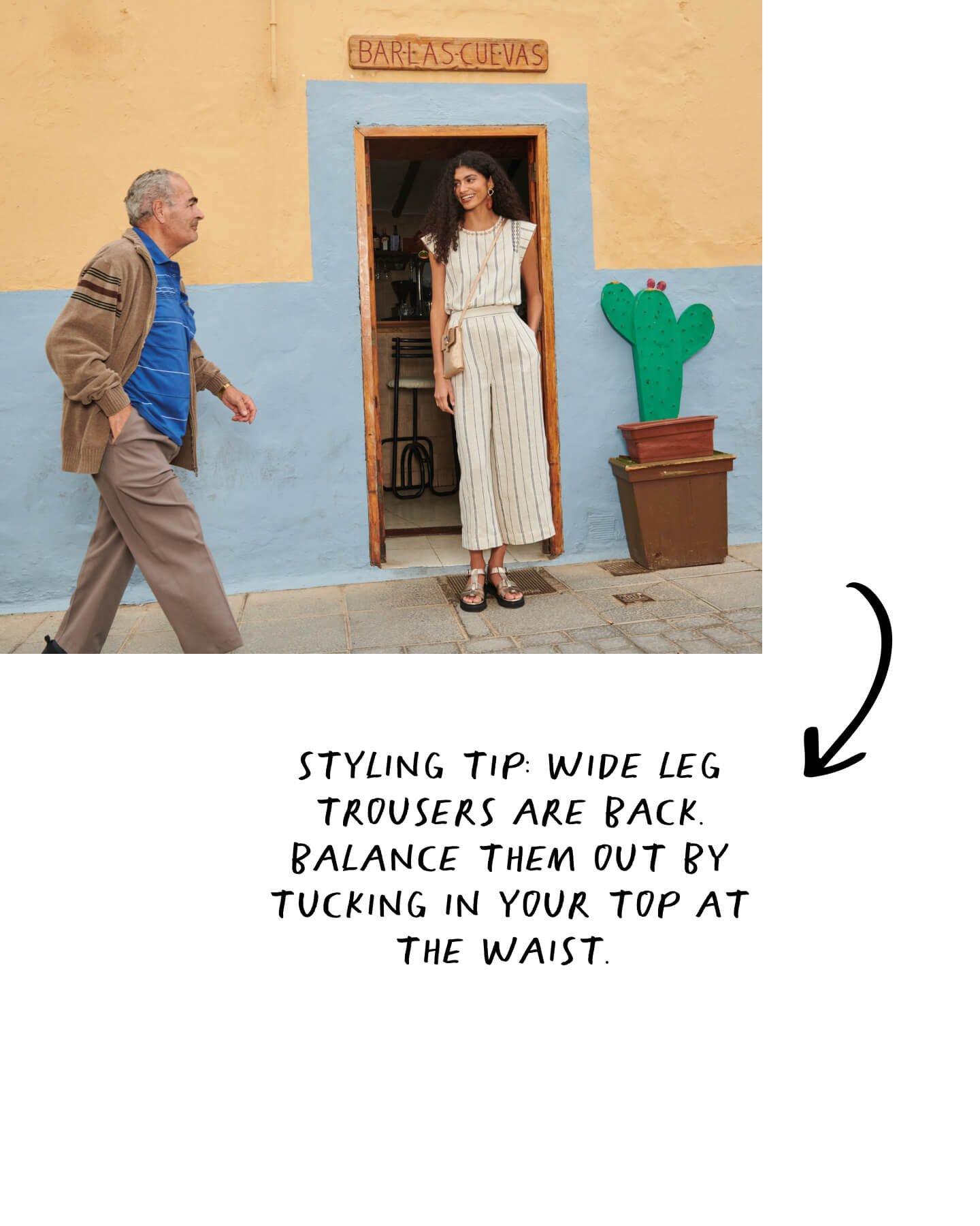 woman wearing linen and man walking past plus text